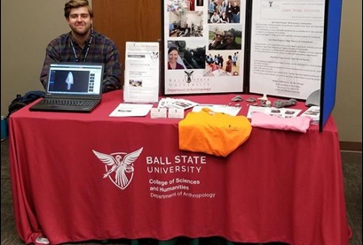 Graduate student, Connor McCoy mans the information table