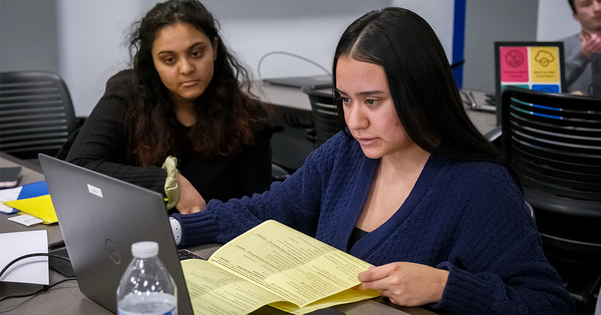 Two Ball State students take part in the VITA program by helping clients prepare taxes 