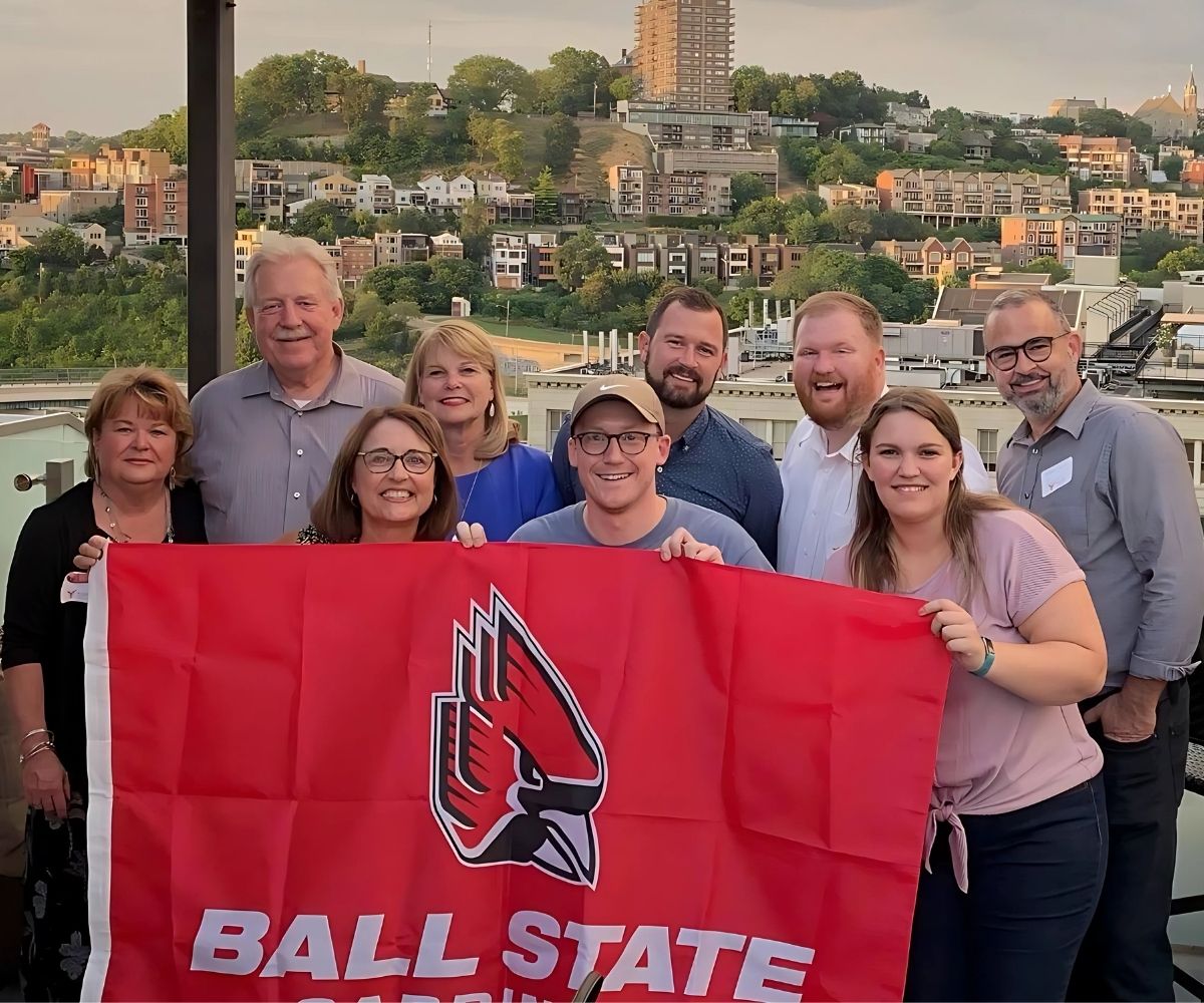 Cincinnati group photo at event holding Ball State Flag