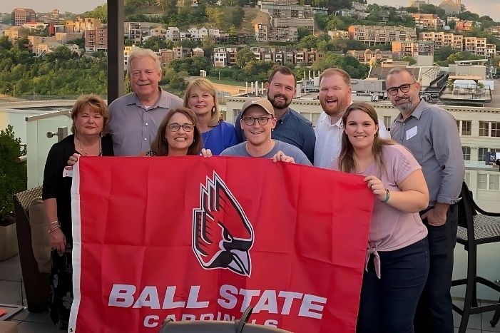 Cincinnati Club at event holding Ball State Flag
