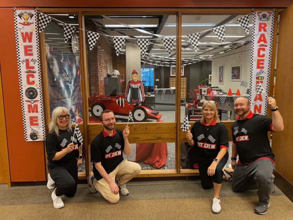People in front of window Race Themed with Car in background