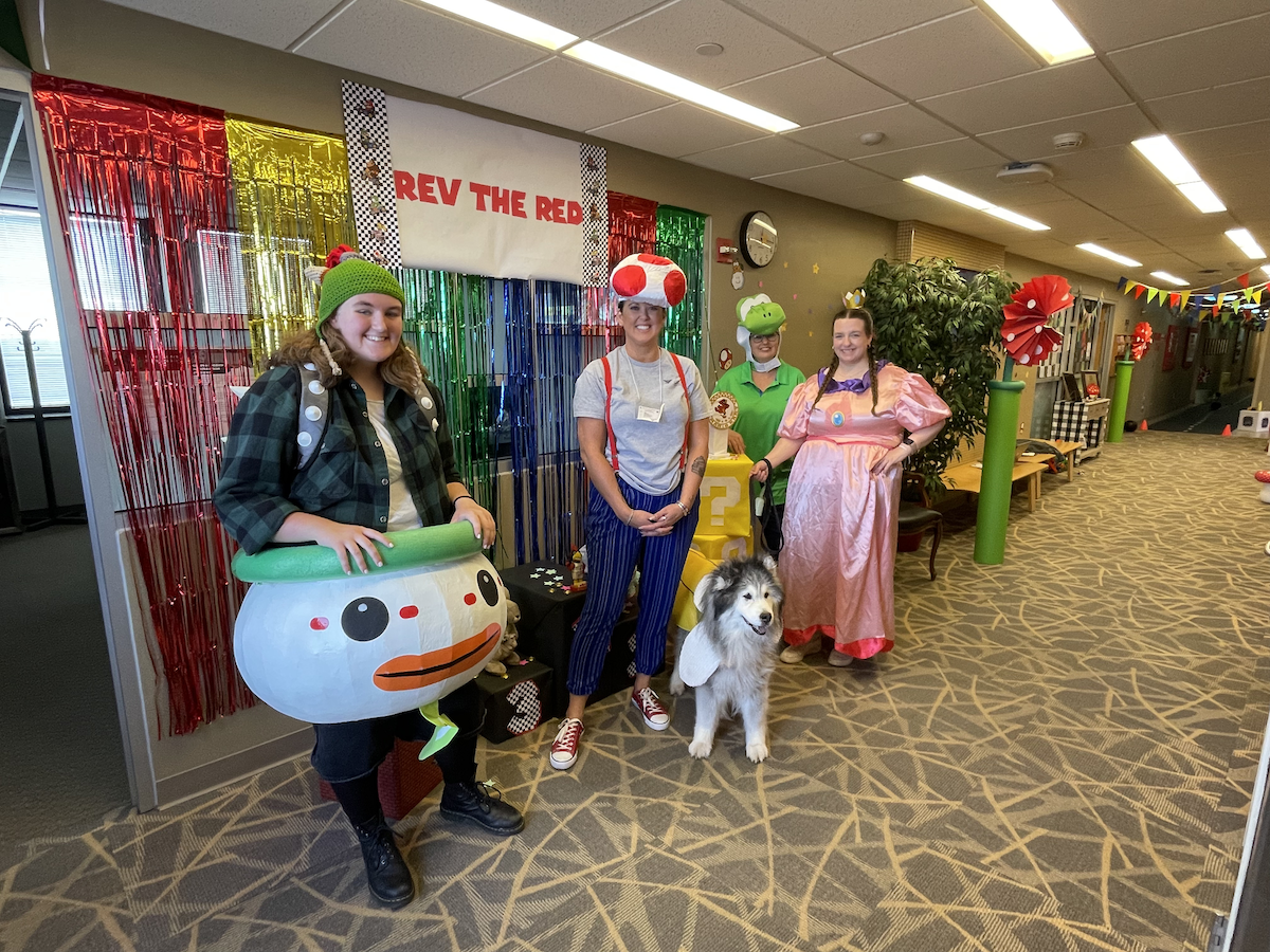 People dressed up as Mario Characters with Dog