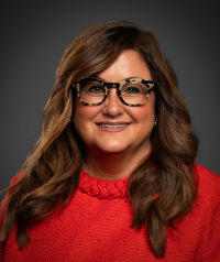 Jean Kramer Crosby in Red Sweater with Dark Gray Background