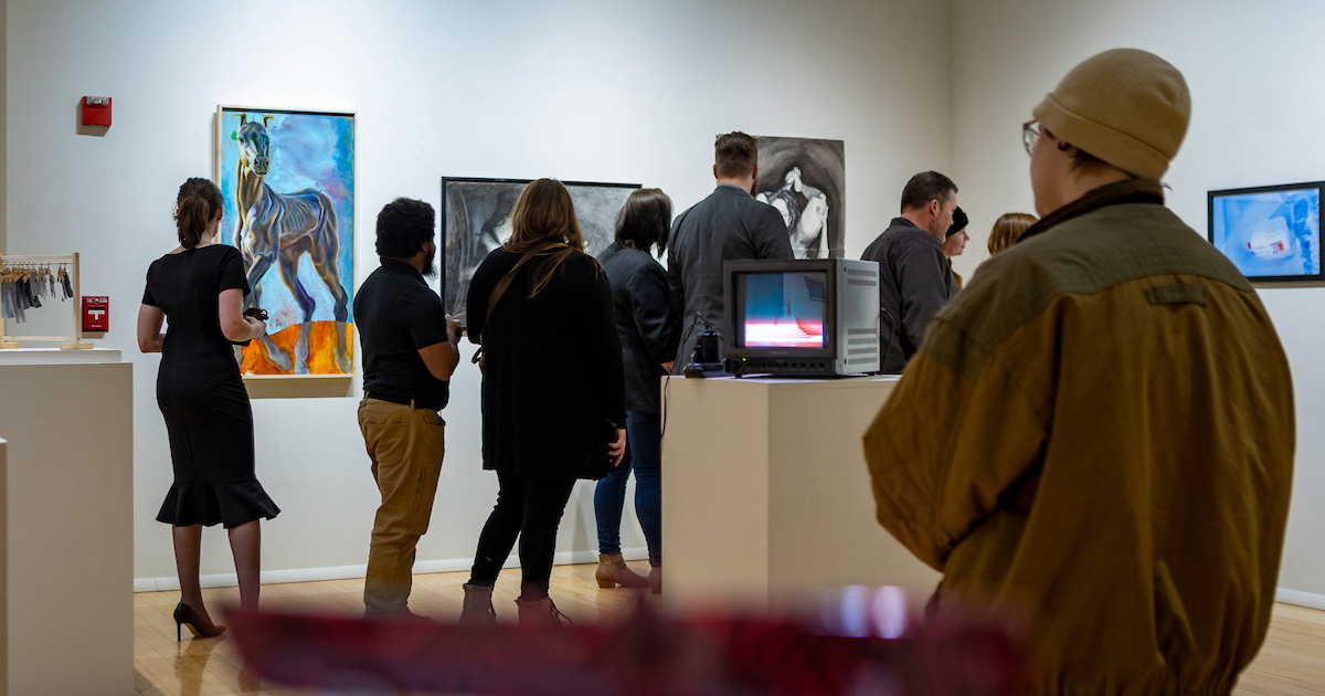 Patrons viewing art in the Ned and Gloria Griner Art Gallery during the 89th Annual Student Art Show.