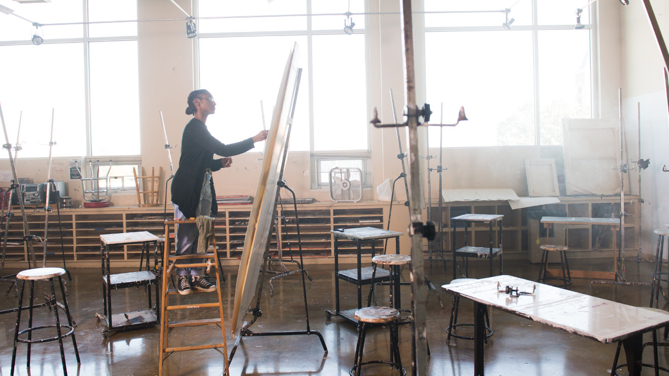Young woman drawing in an empty studio