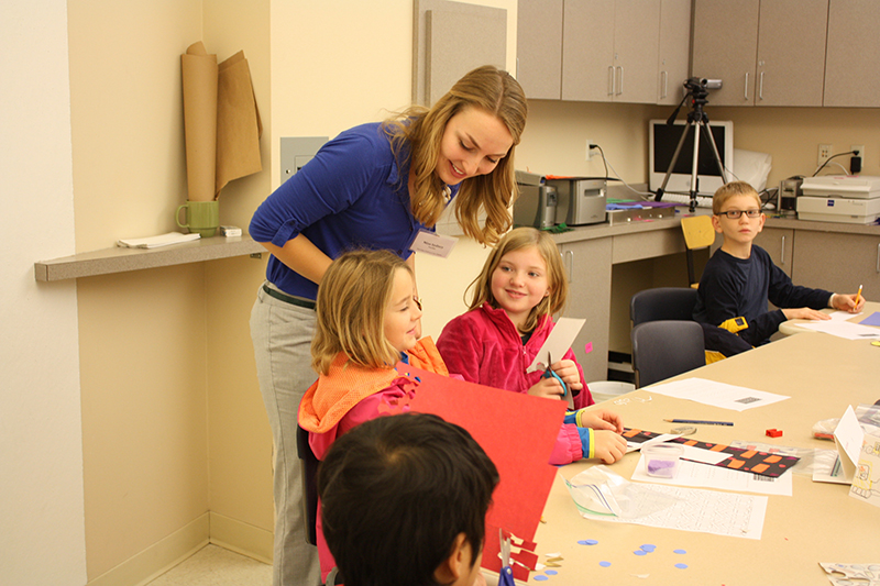 art education student with a classroom of children