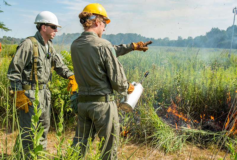 Faculty and student at field burn