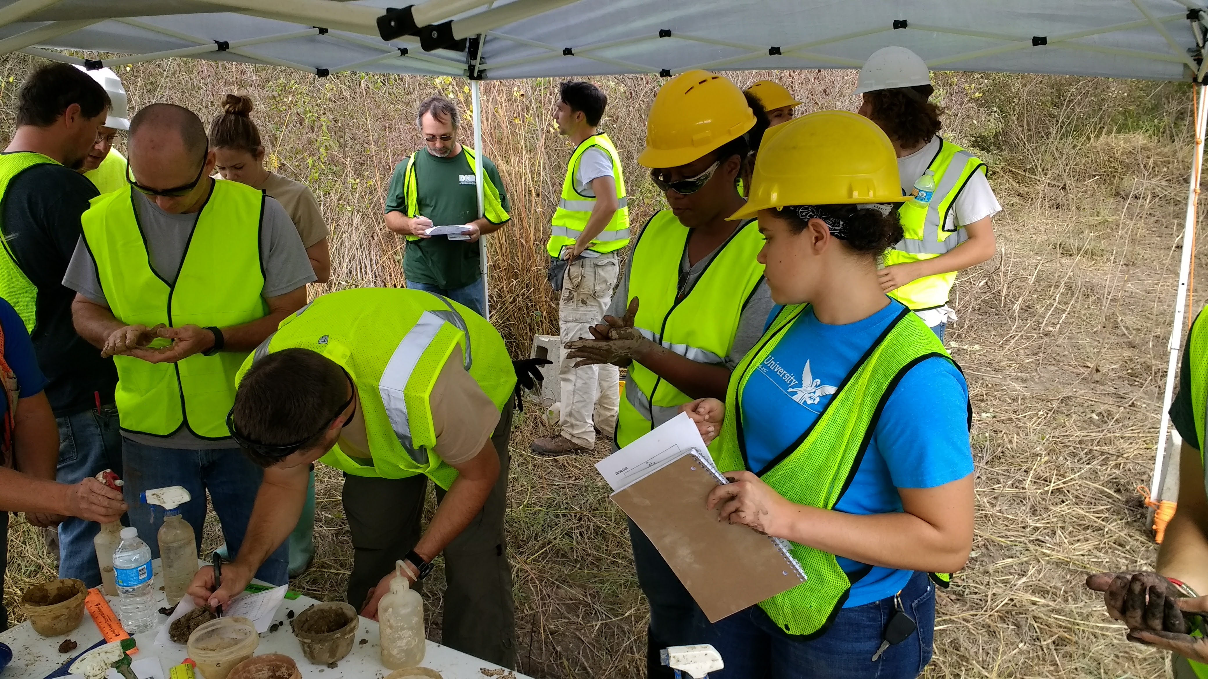Group of people working at wetland restoration site