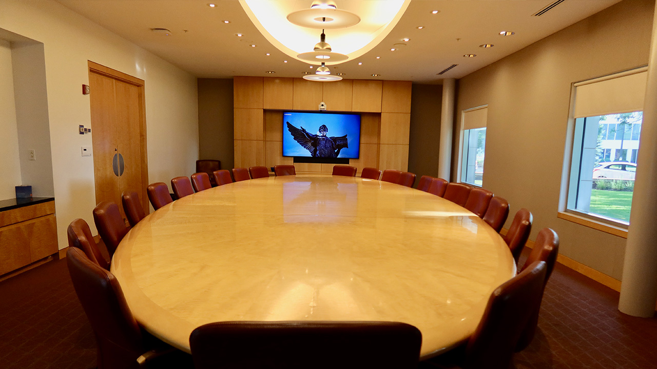 Room with large oval table and chairs.