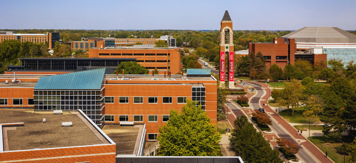 ariel view of campus down McKinley Ave. Buildings and Bell Tower in the background.