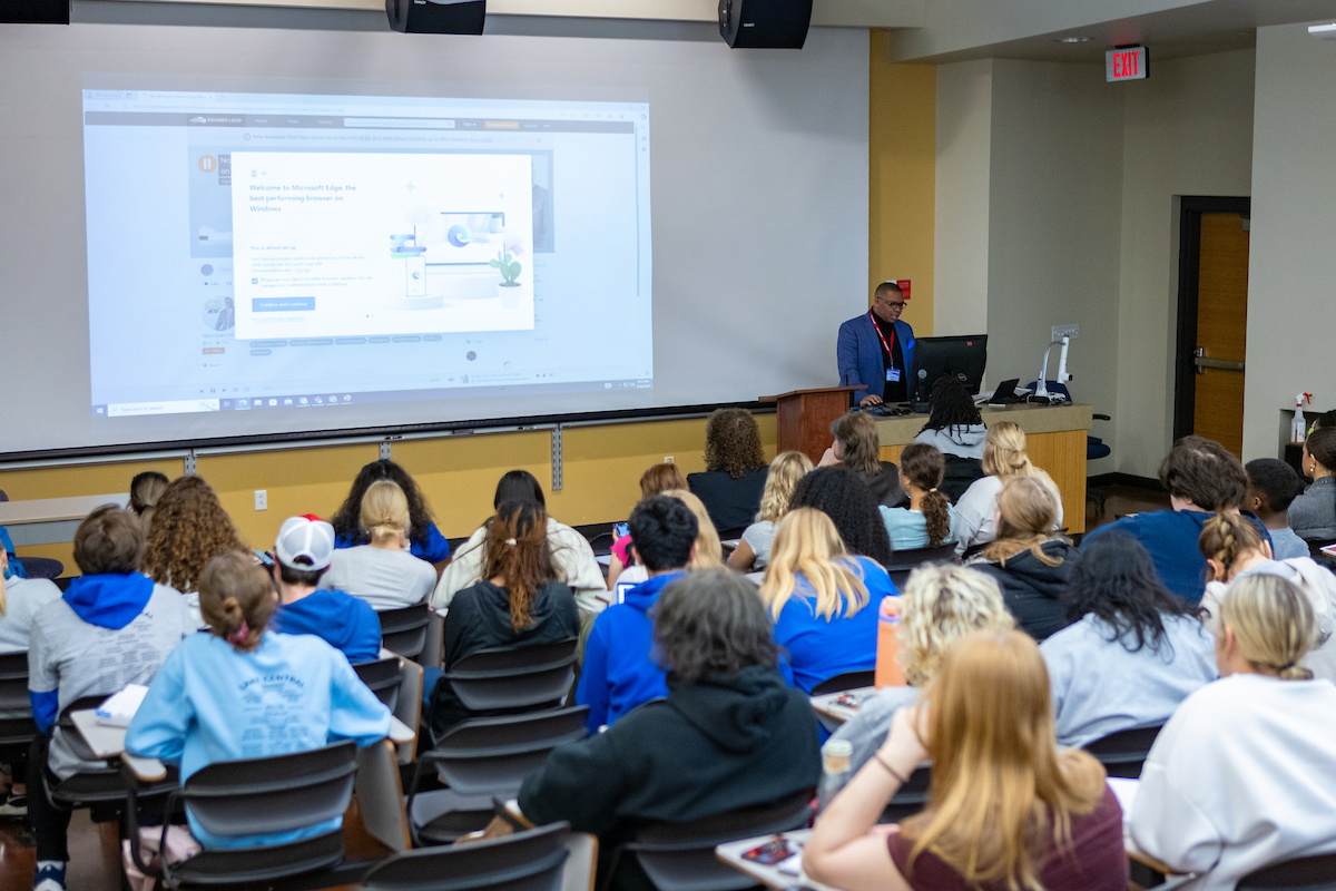 Students in a classroom listening to a speaker.