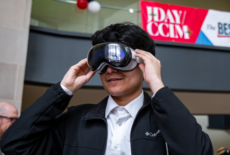 Student wearing virtual reality headset with a black jacket on and a white shirt