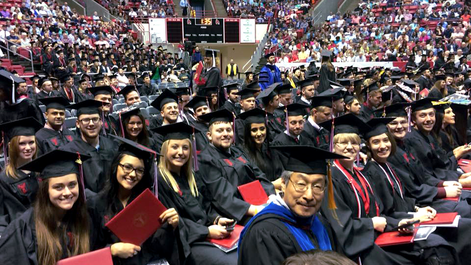 Dr. Taiping Ho with graduates at Commencement