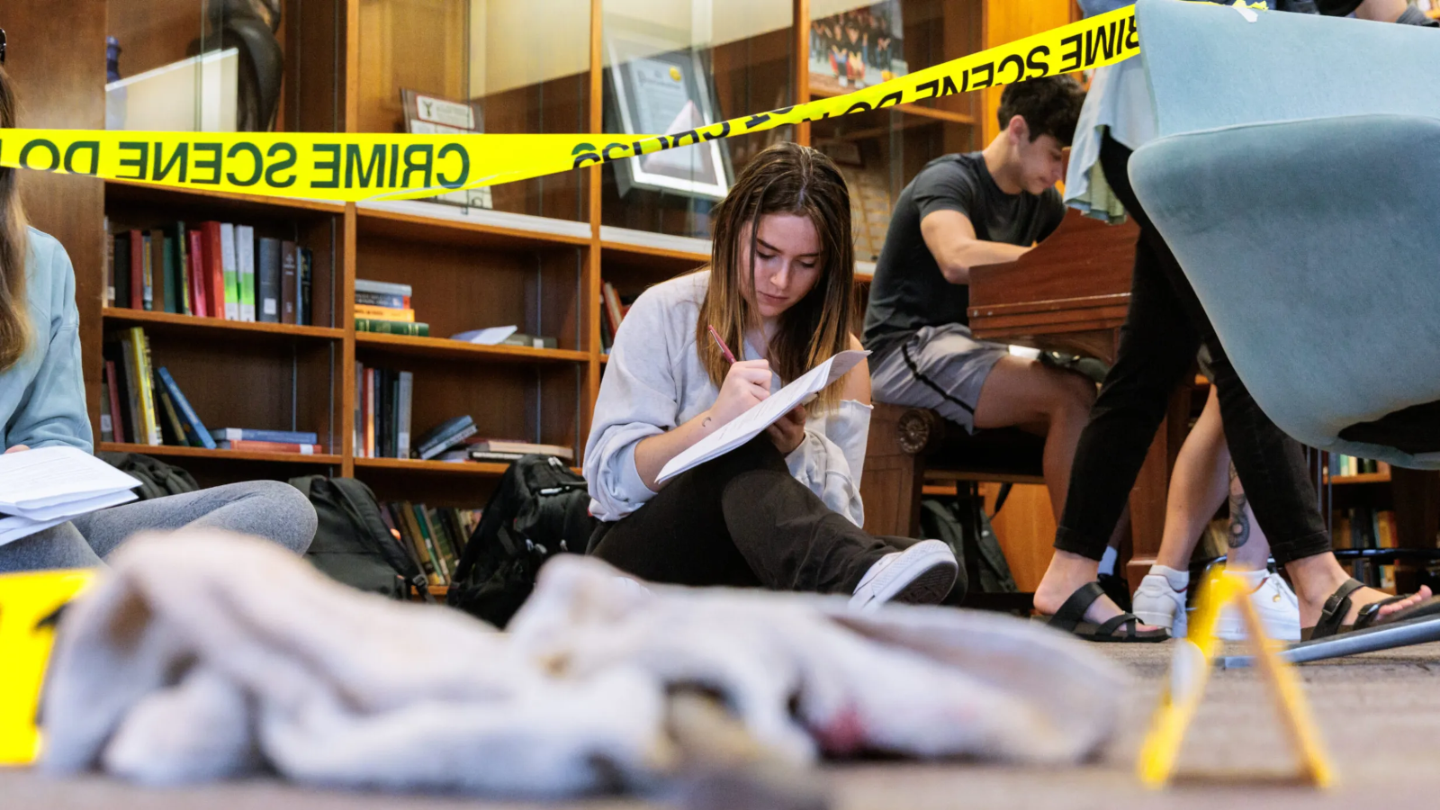 A student in Forensic Science 101 documents a staged crime scene
