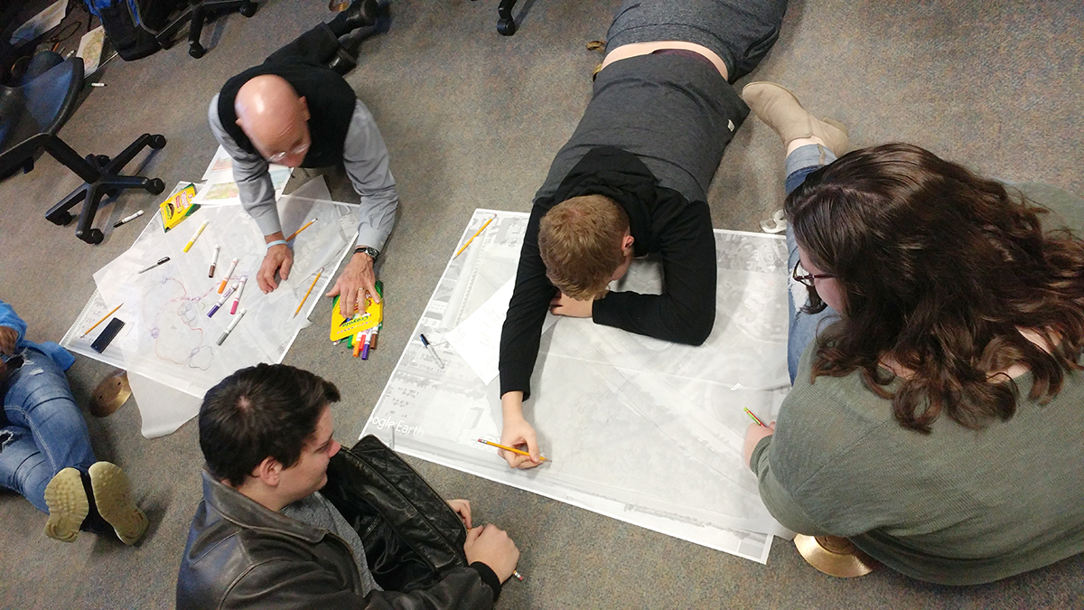 ACE Volunteer with students working on a project.