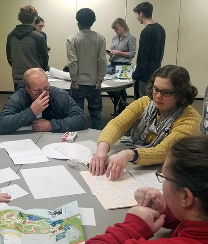 ACE Volunteer with students working on a project.