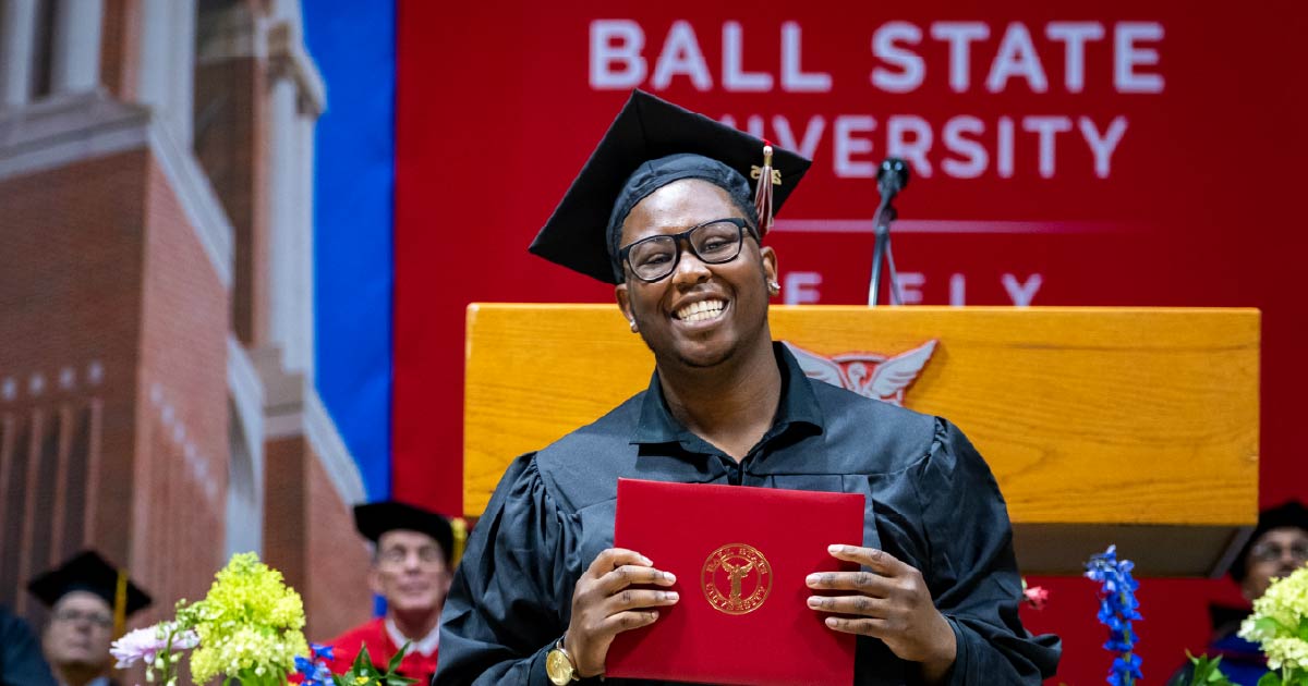 Graduate displays their diploma at the Ball State Summer 2025 commencement ceremony.