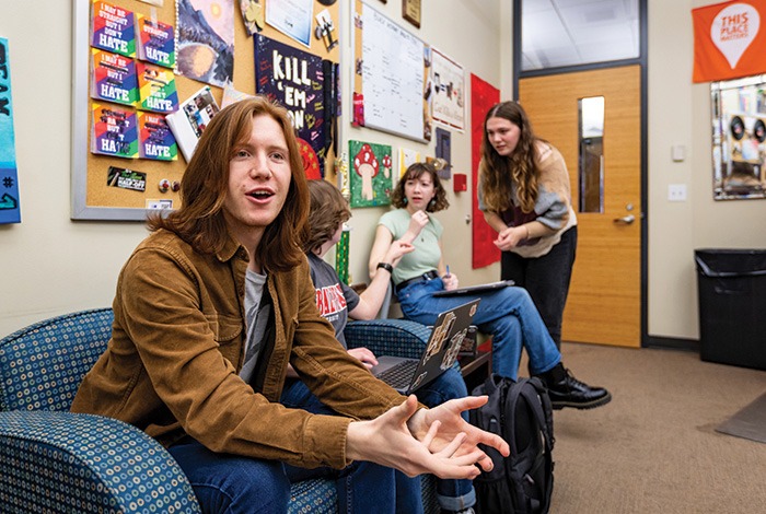 Students in small room interacting with each other