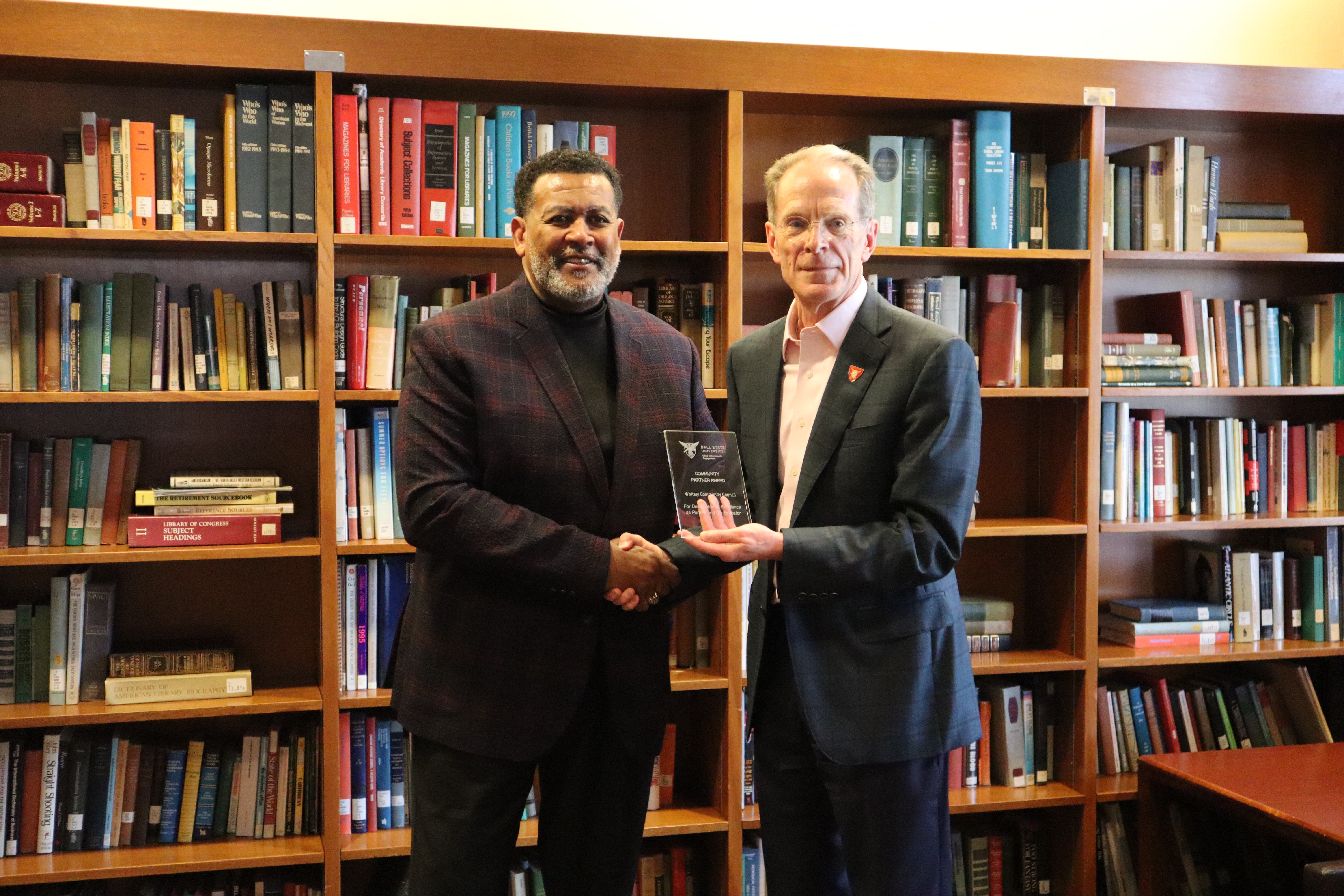 Frank Scott of Whitely Community Council receives a 2025 Outstanding Community Partner Award from President Geoffrey Mearns.