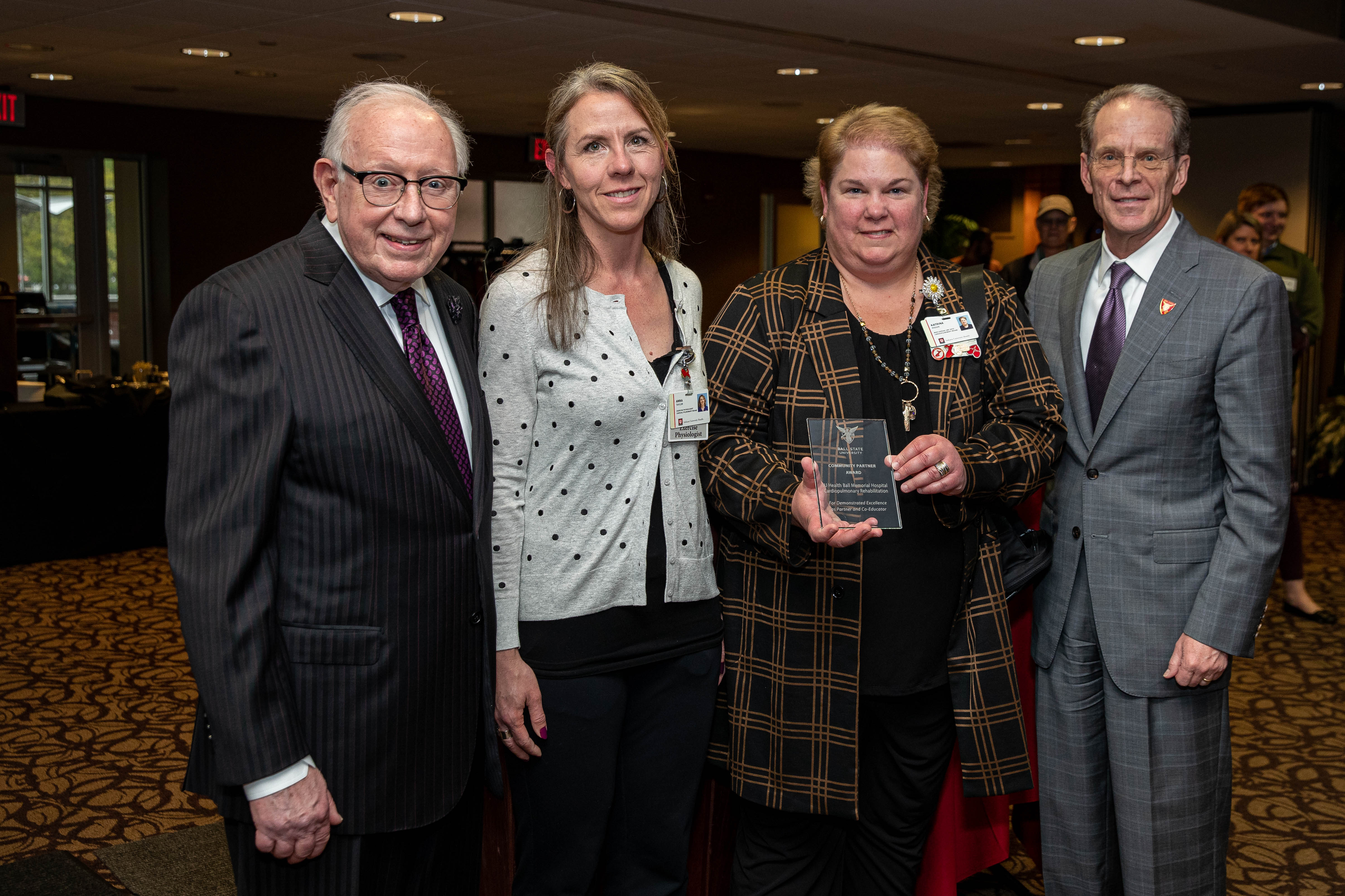 Staff members from IU Health accept stand side-by-side with their award