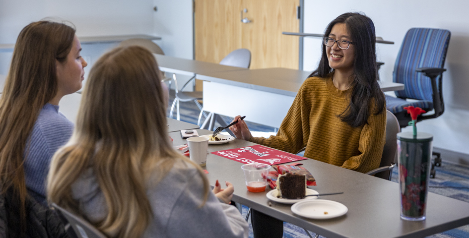 first generation student celebration students talking at table