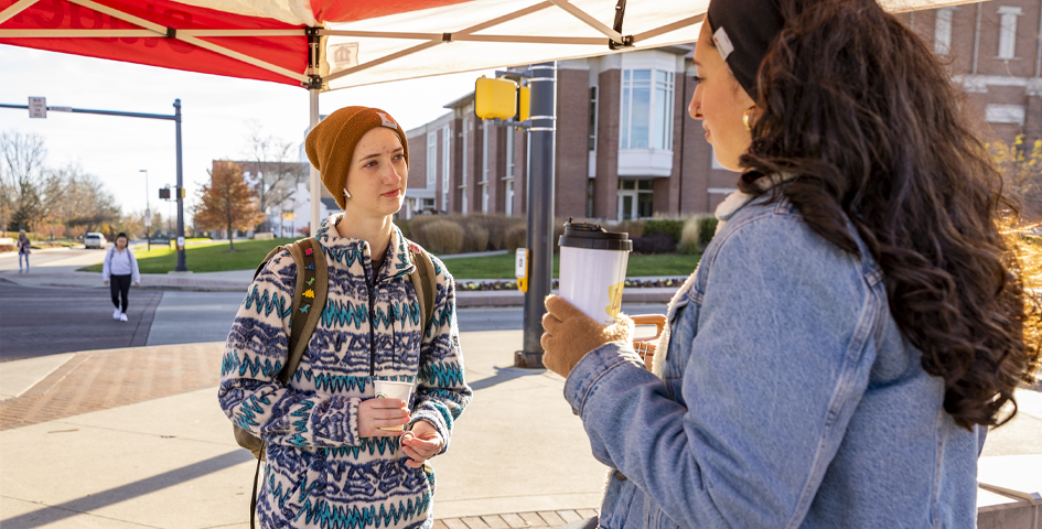 first generation student celebration two students talking