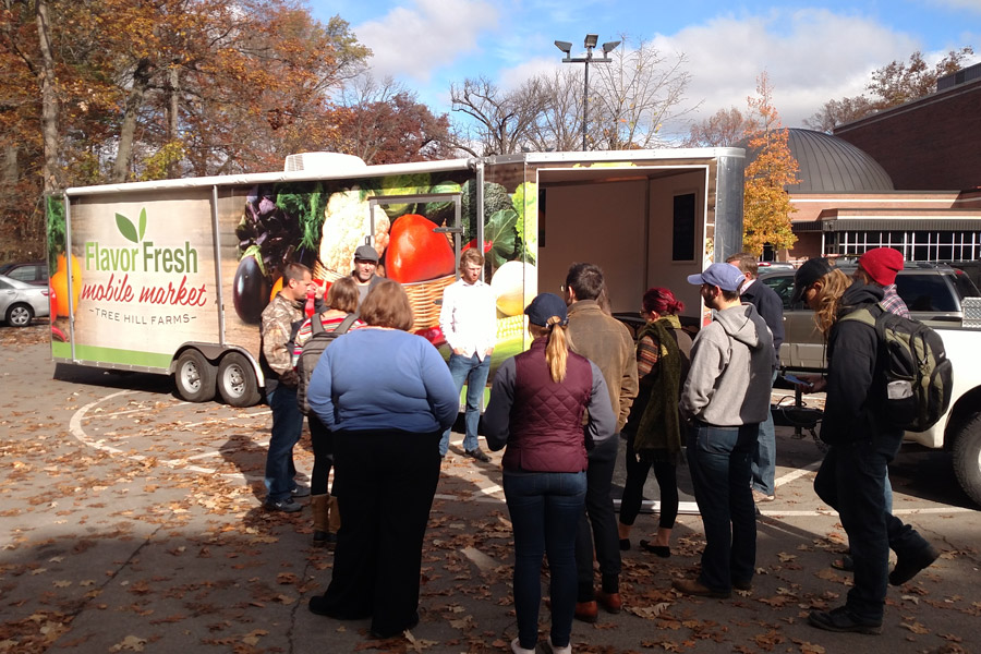 Students gather around a mobile produce truck