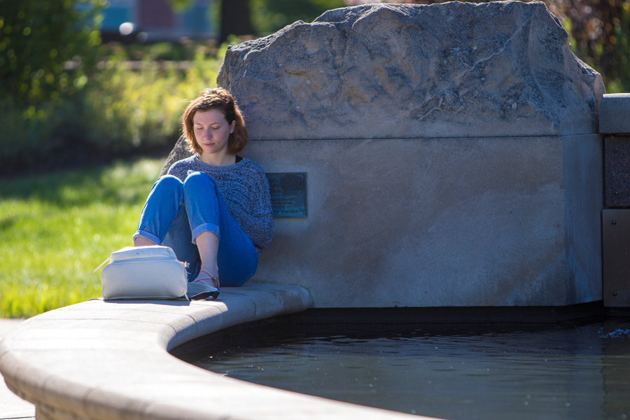 female student reading outside