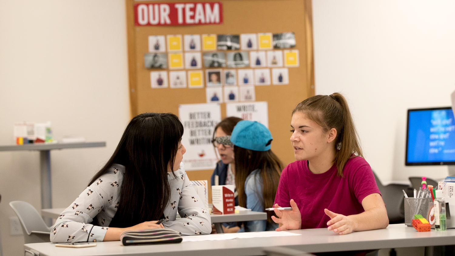 two female students talking in the Writing Center