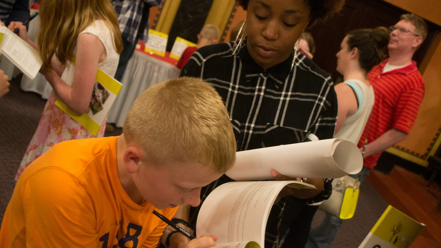 Ball State student helping a young child