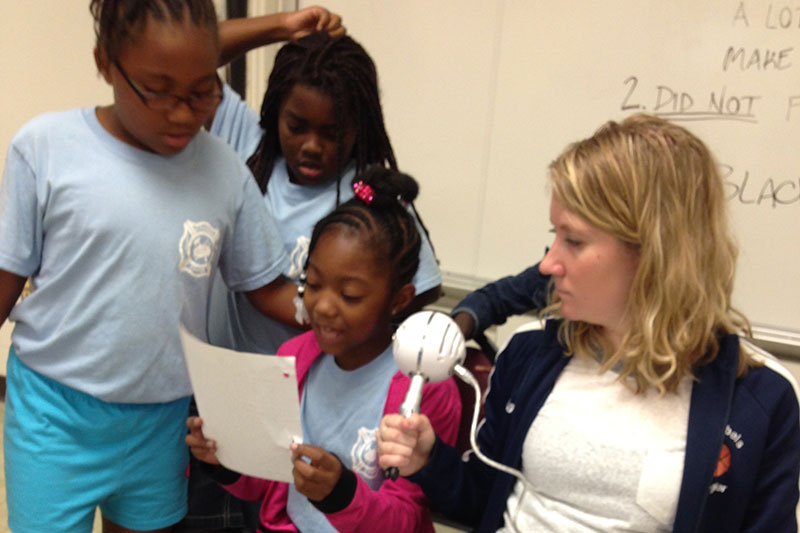 A student working with young children.