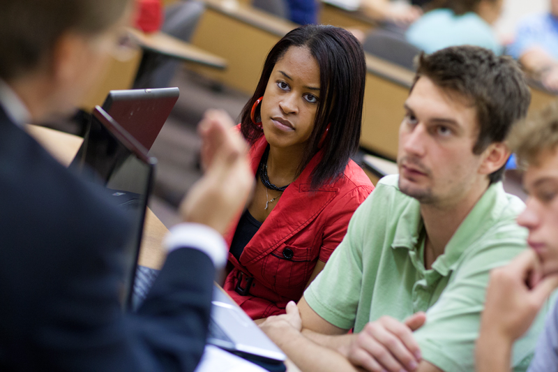 A student listens to a faculty member
