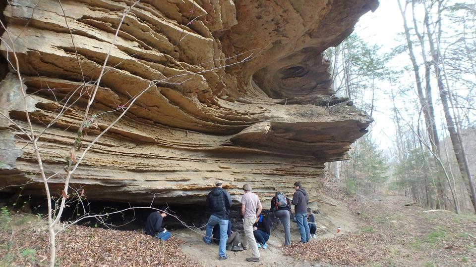 hikers observing a rock formation