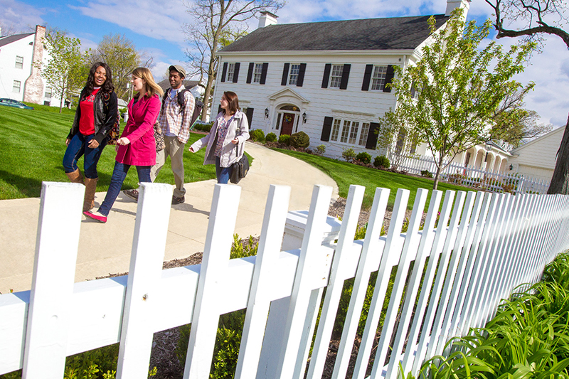 Honors House exterior with students walking out