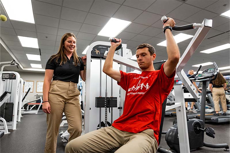 Student on weight machine