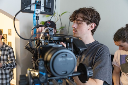 A student adjusts settins on a camera