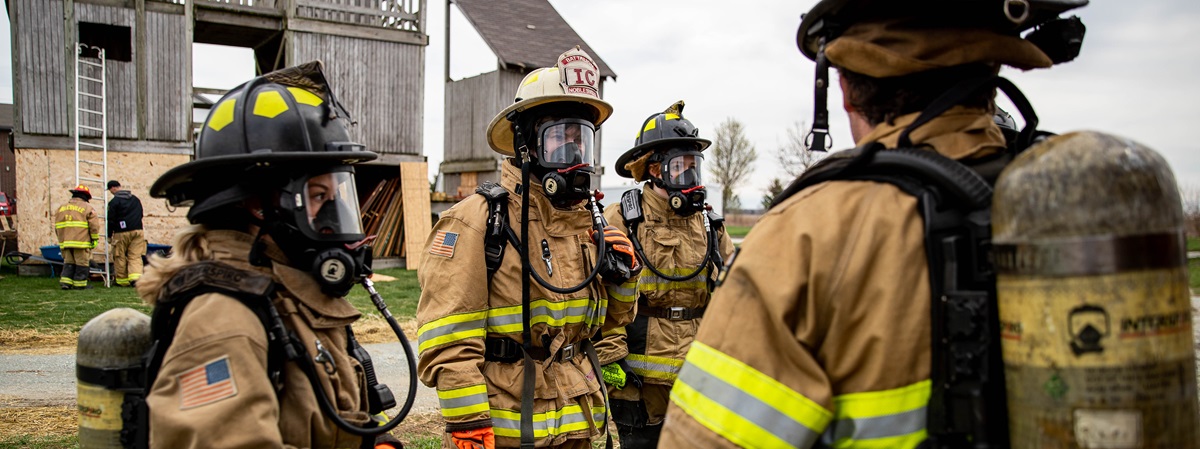 Four people in firefighter suits