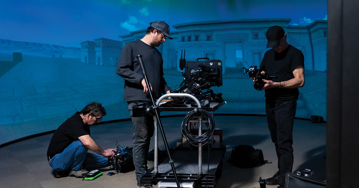 Three technicians setting up camera equipment