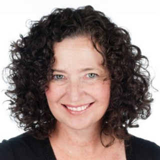 Elizabeth Ferguson, with dark, short curly hair smiling and wearing a black top