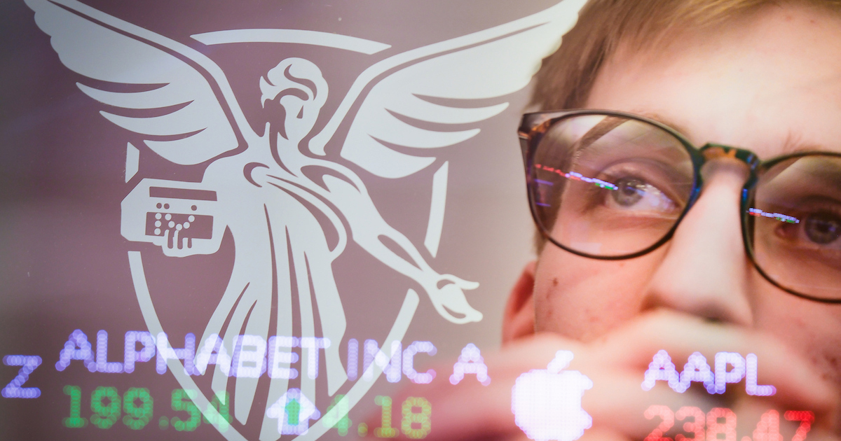 Miller College of Business student behind a transparent screen that is displaying various numbers and words