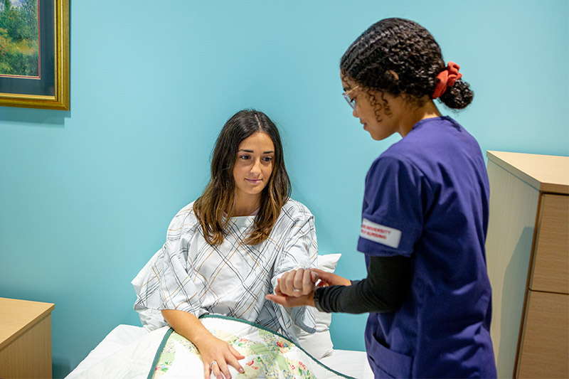 Nursing student working with a patient