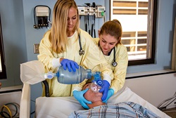 A respiratory therapy student helps a client