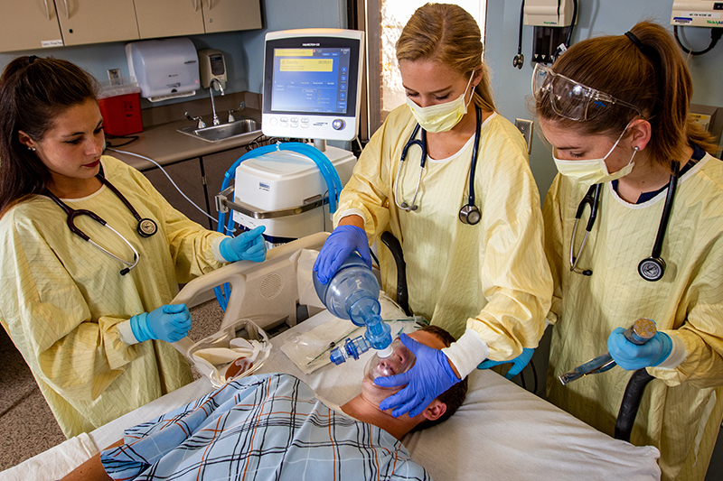 Respiratory therapy students work with a patient