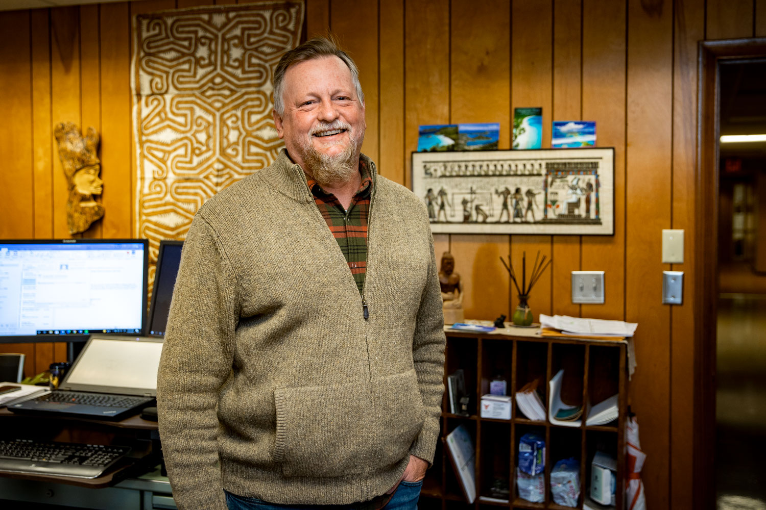 Josh Gruver standing and smiling in his office
