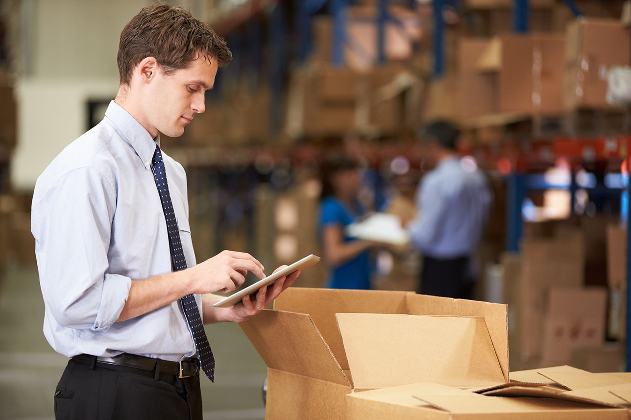 Online logistics bachelor's student working in a warehouse on their senior capstone project