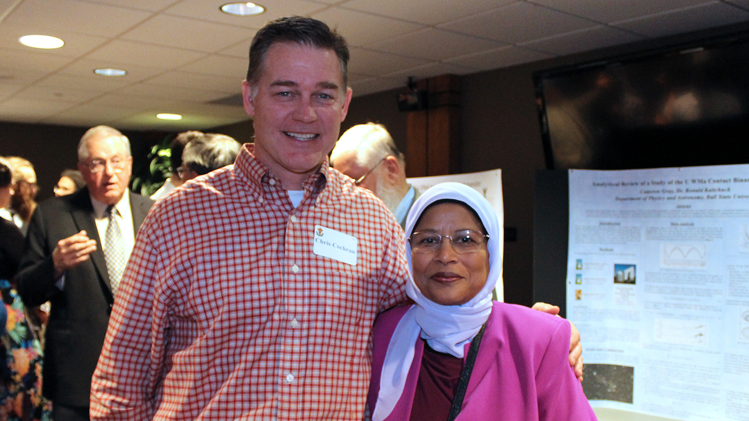 Alumni pose during an event