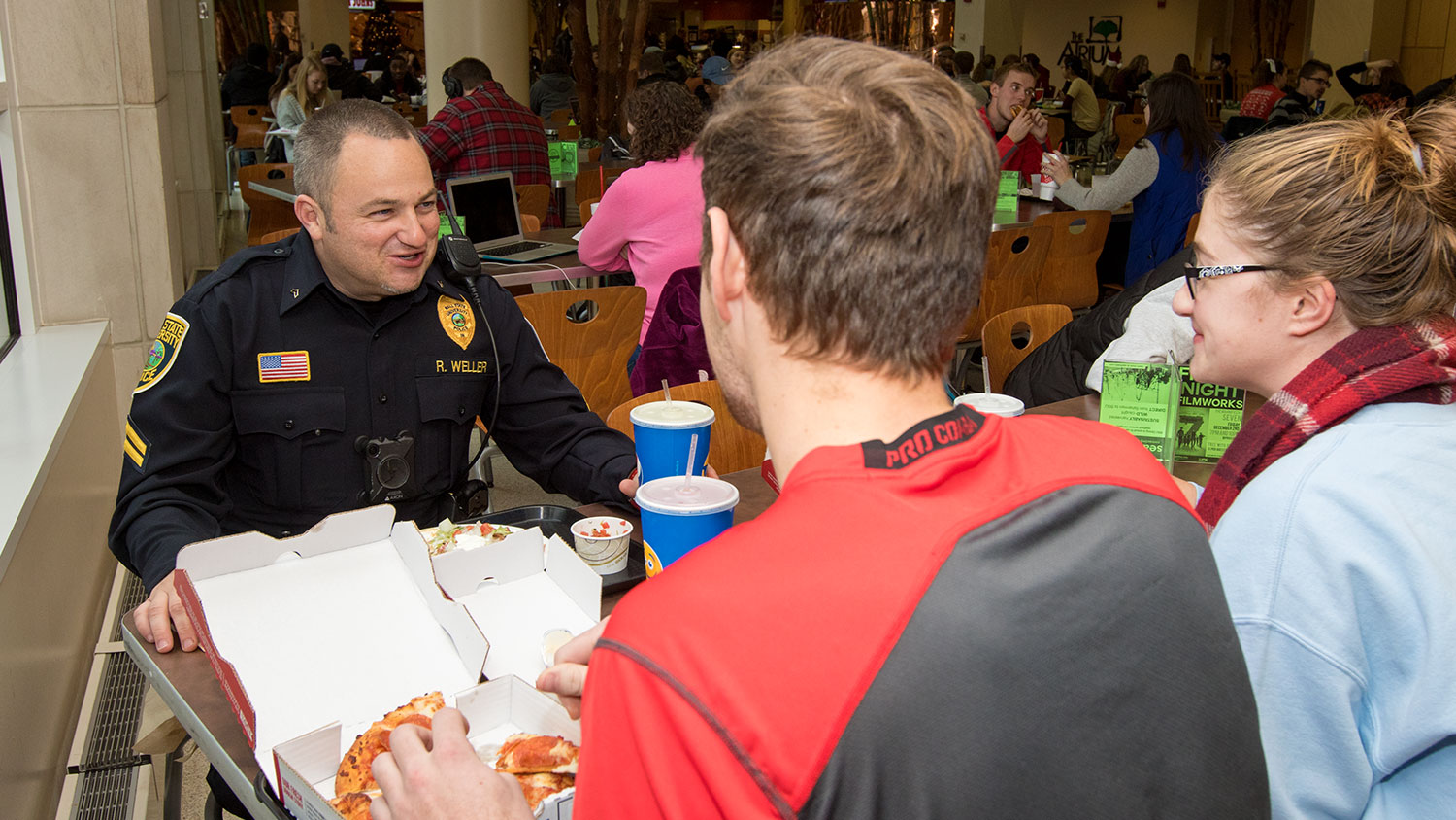 Students eat lunch with officer