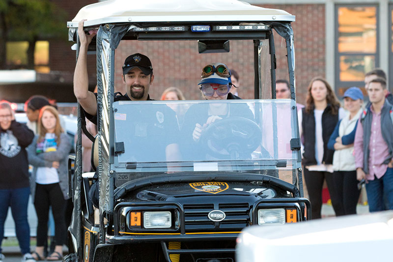 Officer and student in golf cart