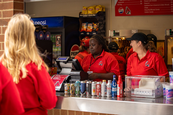 Concession Workers in Window Smiling
