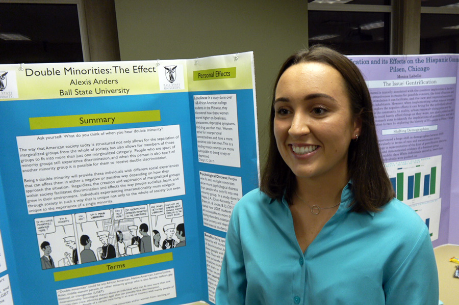 woman standing with research poster